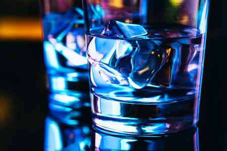 Two glasses of vodka with ice closeup.の写真素材