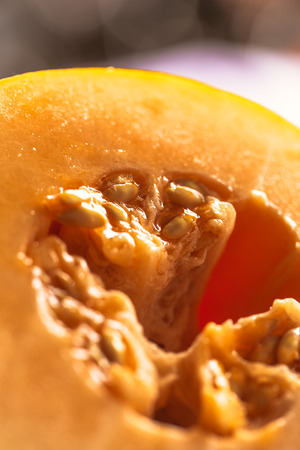 Half of ripe melon close up on blurred background.の写真素材