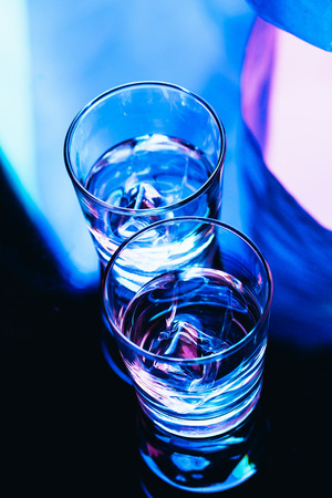 drinking glasses with ice close-up on a dark background.の写真素材