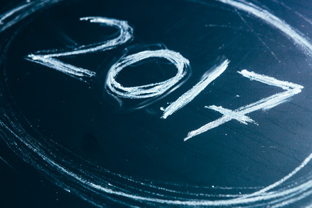 Year number 2017 written with the white chalk on the blackboard.