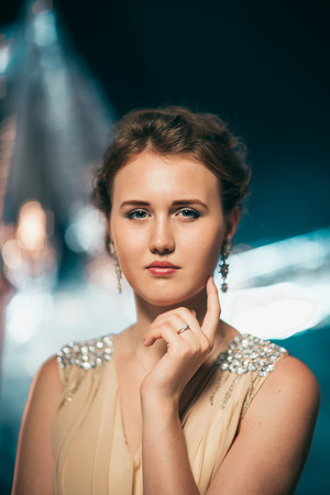 portrait of young girl smiling on a blurred background.の写真素材
