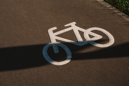 sign cyclist on the background of asphalt road.の写真素材