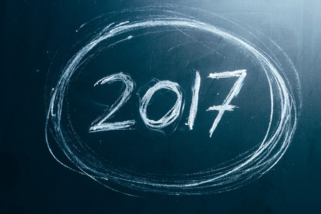 Year number 2017 written with the white chalk on the blackboard.の写真素材
