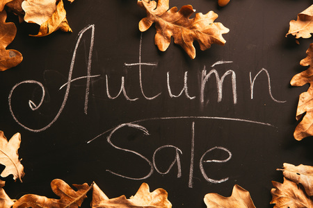 yellow leaves and the inscription autumn on a blackboard.の写真素材