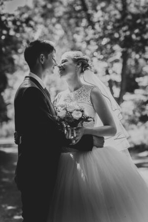 black and white photo portrait of the bride and groom on the forest background.の写真素材