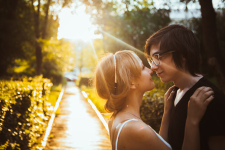 guy and the girl embracing on a background of park.の写真素材