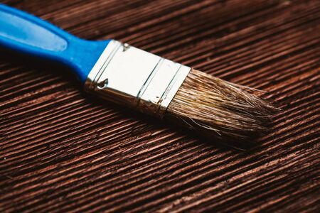 brush to paint on a dark wooden background.の写真素材