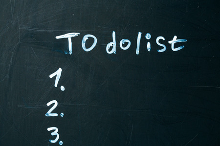 inscription do it list drawn with chalk on a school blackboard dark.の写真素材