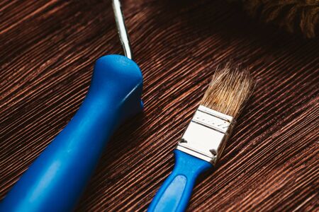 Paint rollers and brush on the dark wooden background.の写真素材