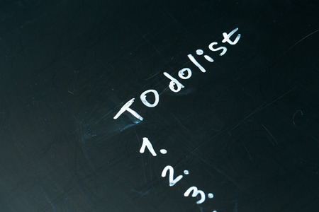 inscription do it list drawn with chalk on a school blackboard dark.の写真素材