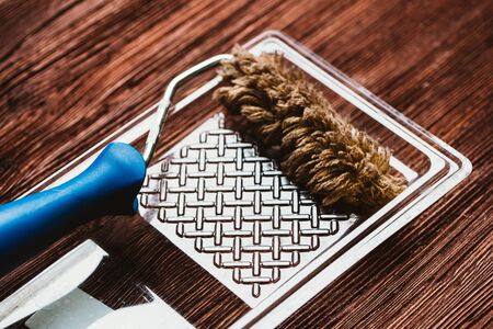 Paint rollers tray on the dark wooden background.の写真素材