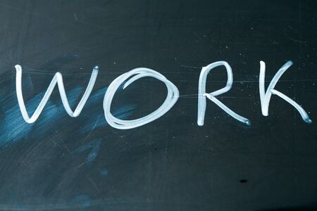 WORK phrase written in chalk on the blackboardの写真素材