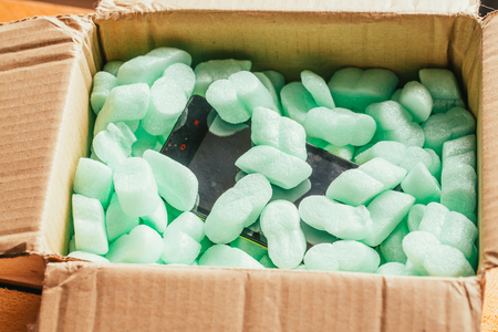 parcel of online shop, phone in a cardboardの写真素材