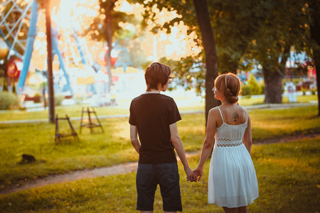 guy and the girl hugging at amusement backgroundの写真素材