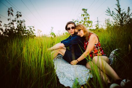 Guy and the girl sitting on the grassの写真素材