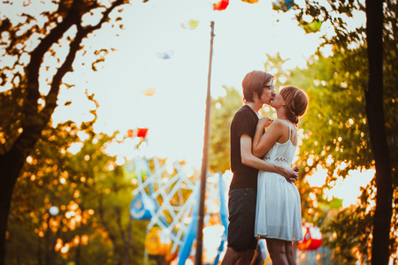 guy and the girl hugging at amusement backgroundの写真素材