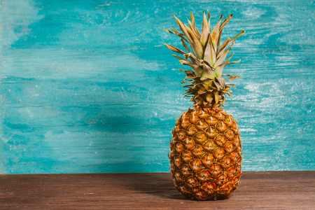 Pineapple is on the table a blue wooden backgroundの写真素材