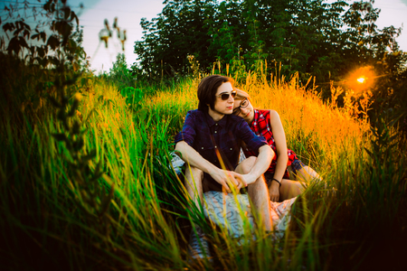 guy and the girl sitting in the grass.の写真素材