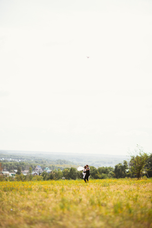 couple bride and groom on field background.の写真素材