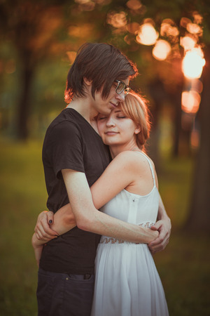 guy and the girl embracing on a background of nature parkの写真素材