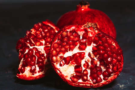 red sliced pomegranate on a blue abstraction backgroundの写真素材