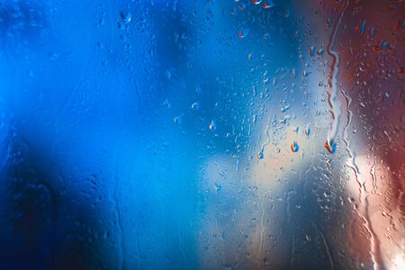 Drops on the glass rain blue backgroundの写真素材