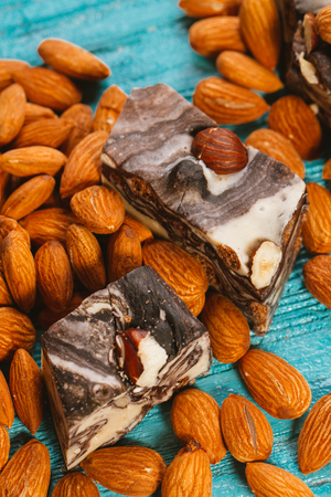 candy paste and almonds on blue wooden backgroundの写真素材