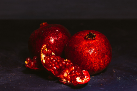 red sliced pomegranate on a blue abstraction backgroundの写真素材