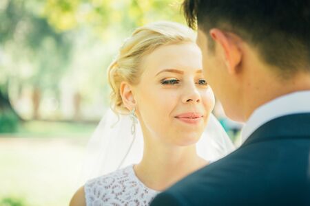 portrait the bride and groom on the background of the park alleyの写真素材