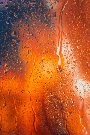 Drops of rain on the window of the car in the eveningの写真素材