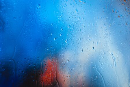 Drops on the glass rain blue backgroundの写真素材