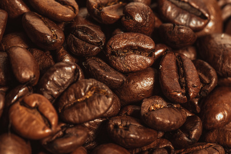 Dark many roasted coffee beans texture backgroundの写真素材