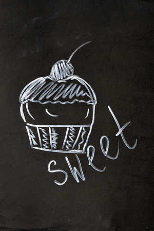 Chalk inscription sweet cupcake with cherryの写真素材