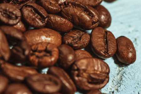 Dark many roasted coffee beans on blue backgroundの写真素材