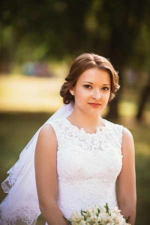 portrait of a young bride on the background the parkの写真素材