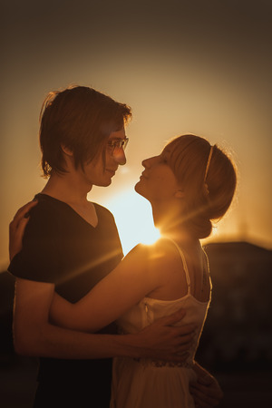guy and the girl hug in the background of the cityの写真素材