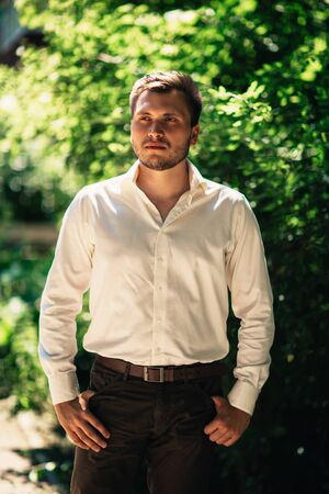 Handsome young man on nature backgroundの写真素材