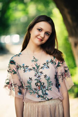 Beautiful young girl on a nature backgroundの写真素材