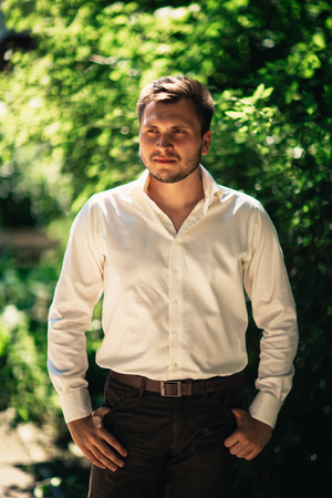 Handsome young man on nature backgroundの写真素材