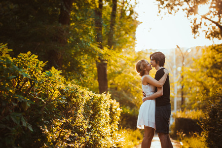 guy and the girl embracing on a background of parkの写真素材