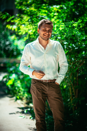 Handsome young man on nature backgroundの写真素材