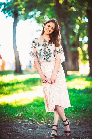 Beautiful young girl on a nature backgroundの写真素材