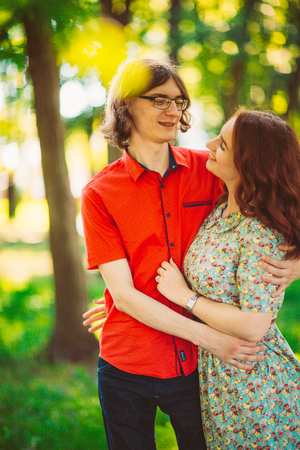 Beautiful young couple on the park backgroundの写真素材