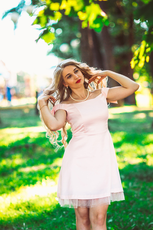 beautiful girl blonde on nature backgroundの写真素材