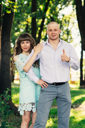 Beautiful young couple on the park backgroundの写真素材
