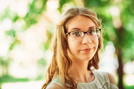 Beautiful young girl on natural backgroundの写真素材