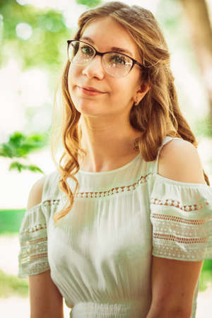 Beautiful young girl on natural backgroundの写真素材