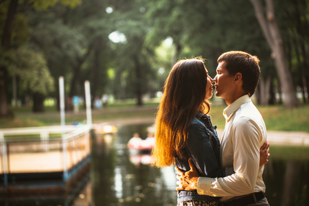 Beautiful young couple on the lake backgroundの写真素材