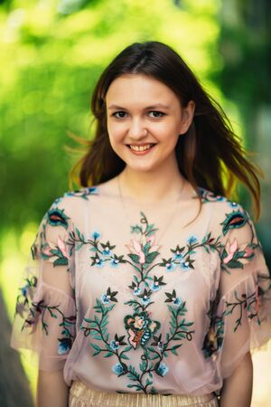 Beautiful young girl on a nature backgroundの写真素材