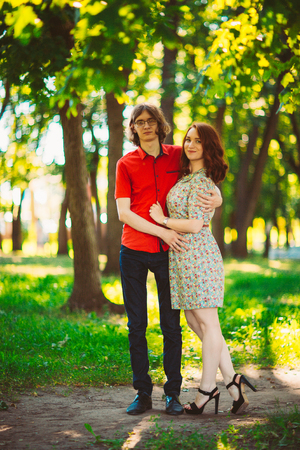 Beautiful young couple on the park backgroundの写真素材
